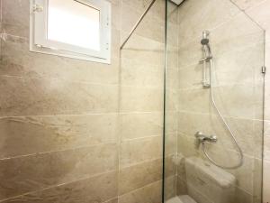 a bathroom with a shower with a glass door at Lafayette Central Apartment-Tunis in Tunis +5 photos