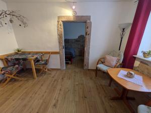 a living room with a table and chairs and a door at 20qmchemnitz in Chemnitz +11 photos