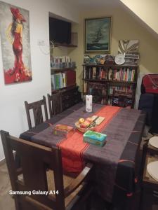 a dining room table with a plate of fruit on it at Mason d'hôtes La re'belle in Céret +11 photos