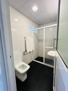 a bathroom with a toilet and a sink at Seaport Negombo in Negombo +16 photos