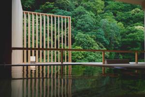 a room with a pool of water in front of a forest at Hakone Pax Yoshino in Hakone +36 photos