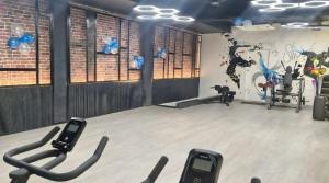 a gym with several exercise bikes in a room at Hotel 7heaven in Kānpur