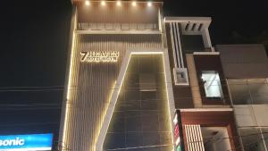 a building with a sign on the side of it at Hotel 7heaven in Kānpur