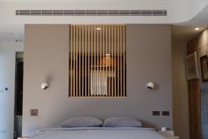 a bedroom with a bed with two pillows on it at 沐美美藝旅 Mumeimei Artel in Tainan
