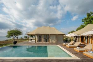 a gazebo with a swimming pool and a tent at Menjangan Dynasty Resort in Banyuwedang