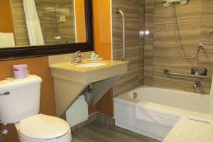 a bathroom with a sink and a toilet and a tub at Comfort Inn Dartmouth in Halifax +23 photos