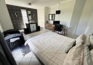 a bedroom with a bed and a tv in a room at One Birdswood in Richards Bay +22 photos