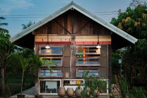 a small house with a gambrel roof at Shine Villa Sukhothai in Sukhothai