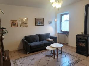 a living room with a couch and a table at Casa Fabiola in Longarone