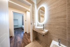 a bathroom with a sink and a mirror at Lumi Stays in Florence