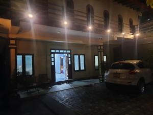 a car parked in front of a building at night at Palm Breeze Kokuvil G1 in Jaffna
