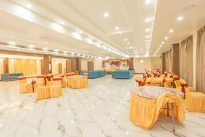a banquet hall with yellow tables and chairs at Hotel Annapurna The Luxurious in Nalanda +97 photos