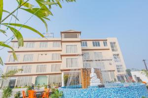 a building with a fountain in front of it at Hotel Annapurna The Luxurious in Nalanda