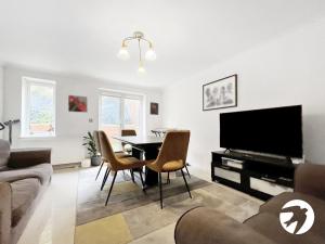 a living room with a table and a tv at 6 Bed Longstay & Shortstay property with Wifi & parking sleeps 14 in Chatham