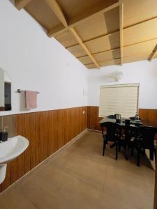 a dining room with a table and a whiteboard on the wall at RiverSoul Pool Villa in North Paravur