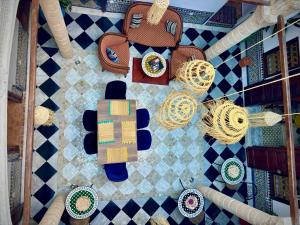 an overhead view of a table with chairs and plates of food at Riad Dar Chaafa 17 in Salé