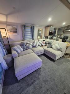 a living room with couches with stuffed animals on them at Cayton Bay Kestrel40 in Cayton +22 photos