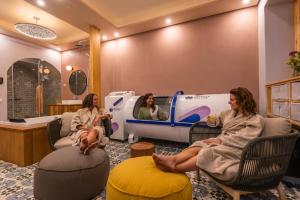 a group of women sitting in a waiting room with a machine at ETHOS Bertolina Wellness Urban Living in Albufeira +105 photos