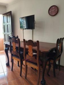a dining room table with two chairs and a tv at Loema-in in Roodepoort
