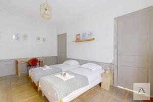 a bedroom with a bed with a tray on it at L'Historique in Rennes