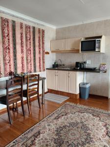 a kitchen with a table and a dining room at Loema-in in Roodepoort