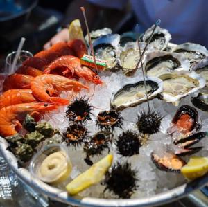 a plate of seafood with shrimp and other foods at Le Bateau du Canal Sète in La Celle-sous-Gouzon