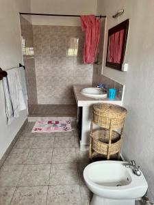 a bathroom with a toilet and a sink at Blue House Watamu in Watamu