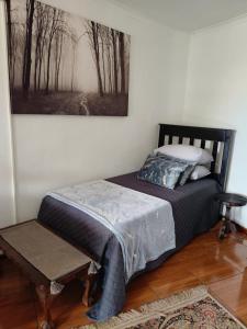 a bed in a room with a picture on the wall at Loema-in in Roodepoort