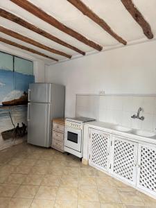 a kitchen with a refrigerator stove and a sink at Blue House Watamu in Watamu +14 photos