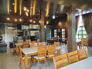 a dining room with wooden tables and chairs at Mountain Deer Resort & Camping in Ban Mung +31 photos