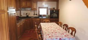a kitchen with a table with a table cloth on it at Maison Sarteur Alloggio ad uso turistico -VDA-LA THUILE- 0065 in La Thuile