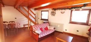 a living room with a couch and a table at Maison Sarteur Alloggio ad uso turistico -VDA-LA THUILE- 0065 in La Thuile