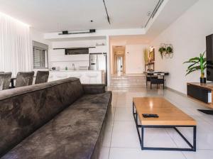 a living room with a couch and a table at villalis bay view in Eilat