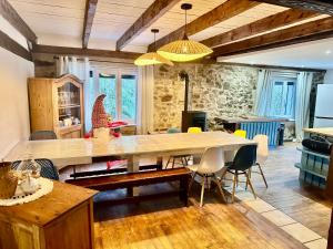 a dining room with a large table and chairs at Le Gîte de Hildegarde in Granges-Aumontzey