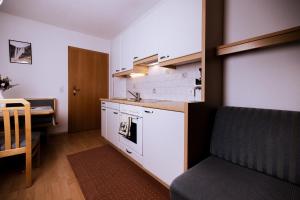 a kitchen with a sink and a stove top oven at Appartement Susanna in Fügen