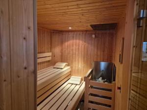 a wooden sauna with a television in it at Pfandlinghof in Grossarl