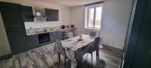 a kitchen with a table with a candle on it at Le Duplex in Coligny +5 photos