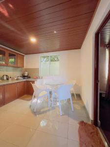 a kitchen with a table and chairs in a kitchen at Blackpool Hub in Nikawatawana +6 photos