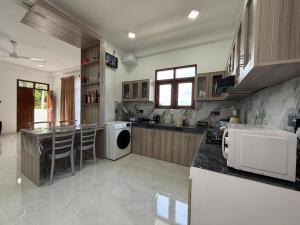 a large kitchen with a counter and a dishwasher at Southern Hight's Villa in Unawatuna