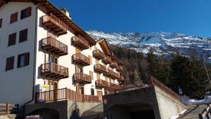 a building with balconies on it with a mountain at Monolocale Belvedere in La Thuile