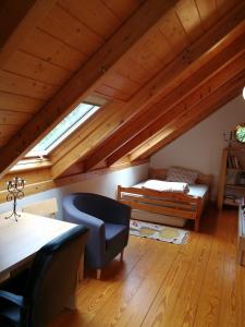 a attic room with a bed and a table and a chair at Villa with big garden in Athens