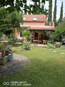 a house with a patio and a yard at Villa with big garden in Athens
