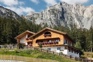 a house in front of a mountain at Garni Ciasa Urban in Badia