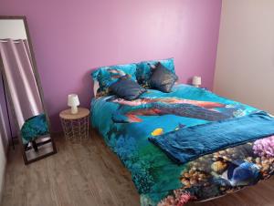 a bedroom with a bed with an under the sea bedspread at Loire et Vignes in Saint-Bouize