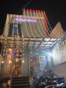 a group of motorcycles parked in front of a building with lights at Raghunandan dham in Chitrakoot