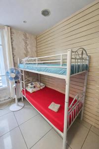 two bunk beds in a room with a red rug at Korean Style Minbak Number Two PARIS in Paris