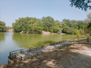 a bridge over a body of water with trees at Maison 3 chambres - 6-8 personnes - piscine chauffée - jacuzzi - internet - parking - Idéal familles & pros in Monflanquin