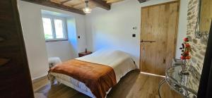 a bedroom with a bed and a glass table at Oustal de Piarelle in Saint-Jean-du-Bruel