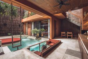 an indoor swimming pool in a house at Sana Vie Villa Seminyak by Ini Vie Hospitality in Seminyak