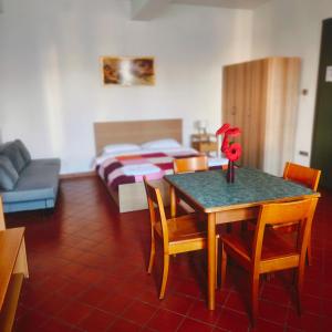 a room with a table and chairs and a bed at Student's Hostel Della Ghiara in Reggio Emilia +41 photos